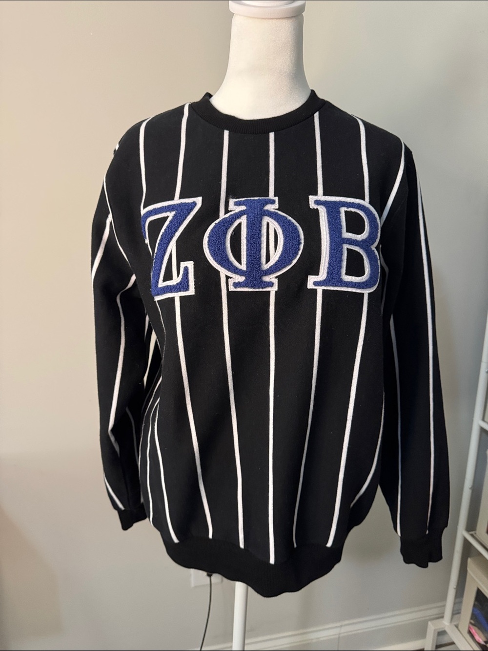 Black Crewneck Sweater with White Pinstripes and Blue Lettering